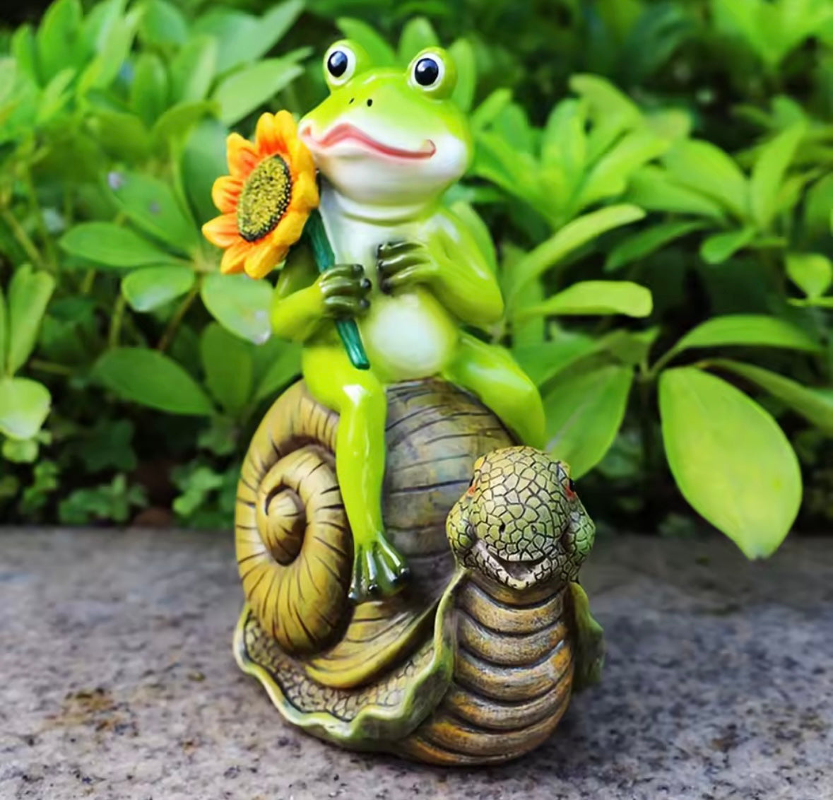frog riding snail statue